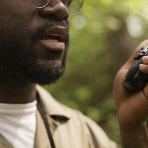 side-view-forest-warden-holding-walkie-talkie